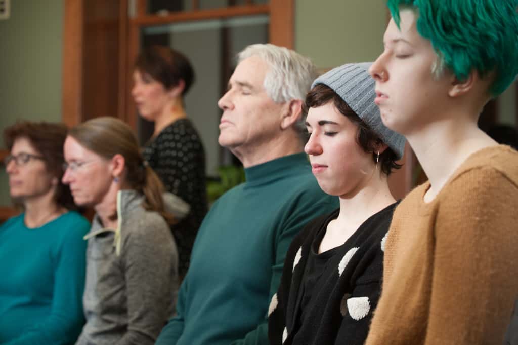 people of all ages meditating
